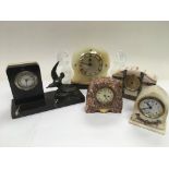 Five French metal and marble mantle clocks.