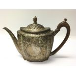 A George III silver tea pot with wooden handle. We