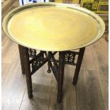 An Anglo Indian type brass table on folding base p