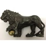 A spelter model of a lion holding a ball.Approx 18