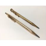 Two rolled gold pencils.