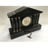 A black slate mantle clock with Corinthian column supports and a 1930's oak cased mantle clock