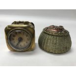 A small brass alarm clock together with an inkwell