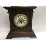 A walnut cased ansonia mantal clock the circular dial with Roman numerals and a slate mantal clock