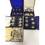 Five cases of various silver spoons including exam