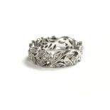 A small ladies 18ct white gold ring of open folate design, set with numerous small diamonds, ring