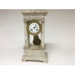 A alabaster four pillar clock the enamel dial with Roman numerals with visible sunburst pendulum