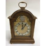 A small Charles Frodsham oak mantle clock with Roman numeral dial in gilt surround.Approx 23cm high