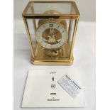 A Jaeger-LeCoultre Atmos clock with booklet and guarantee.Approx 16x23cm