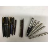 A collection of vintage pens including Parker Duofold and Conway fountain pens