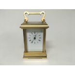 A brass cased carriage clock the enamel dial with Roman numerals