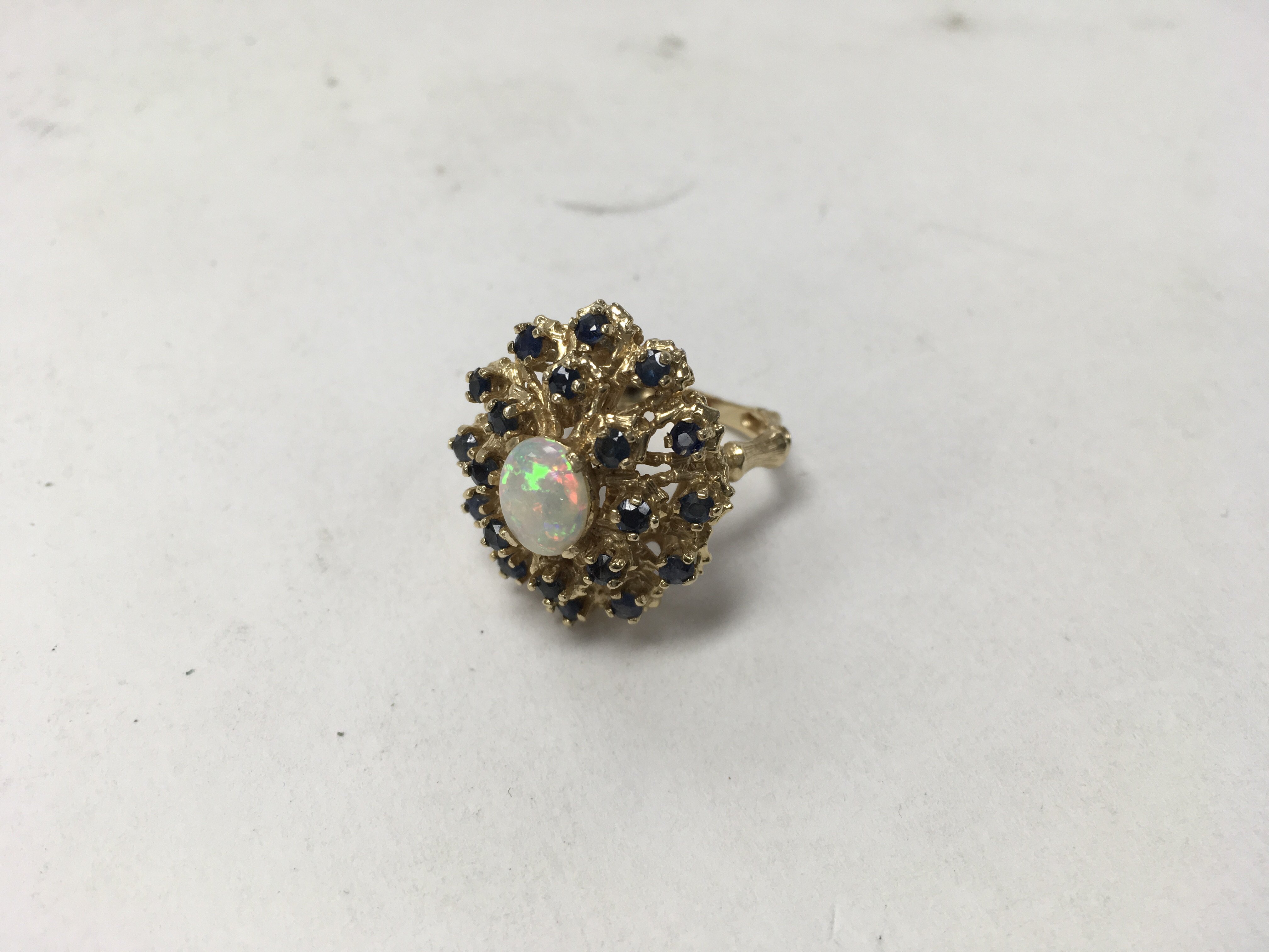 A 14ct opal and sapphire cluster ring. Weight appr