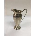 A silver cream jug, Birmingham 1935, approx 13cm.