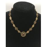 A 9ct gold necklace set with cut stones in piercew