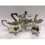 A three piece silver tea service raised on lion pa