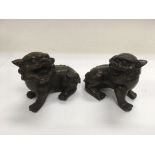A pair of bronzed dogs of Fo temple dogs, approx heights between 7cm and 7.5cm.