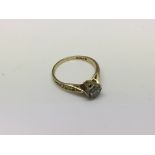 An 18ct gold ring set with a small diamond, approx