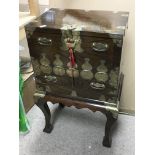 An Oriental style cabinet on a seperate stand, both embellished with brass decoration, approx 42cm x
