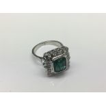 A 14ct white gold emerald and diamond ring, approx