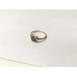 A gold ring set with white stones. Size approx K