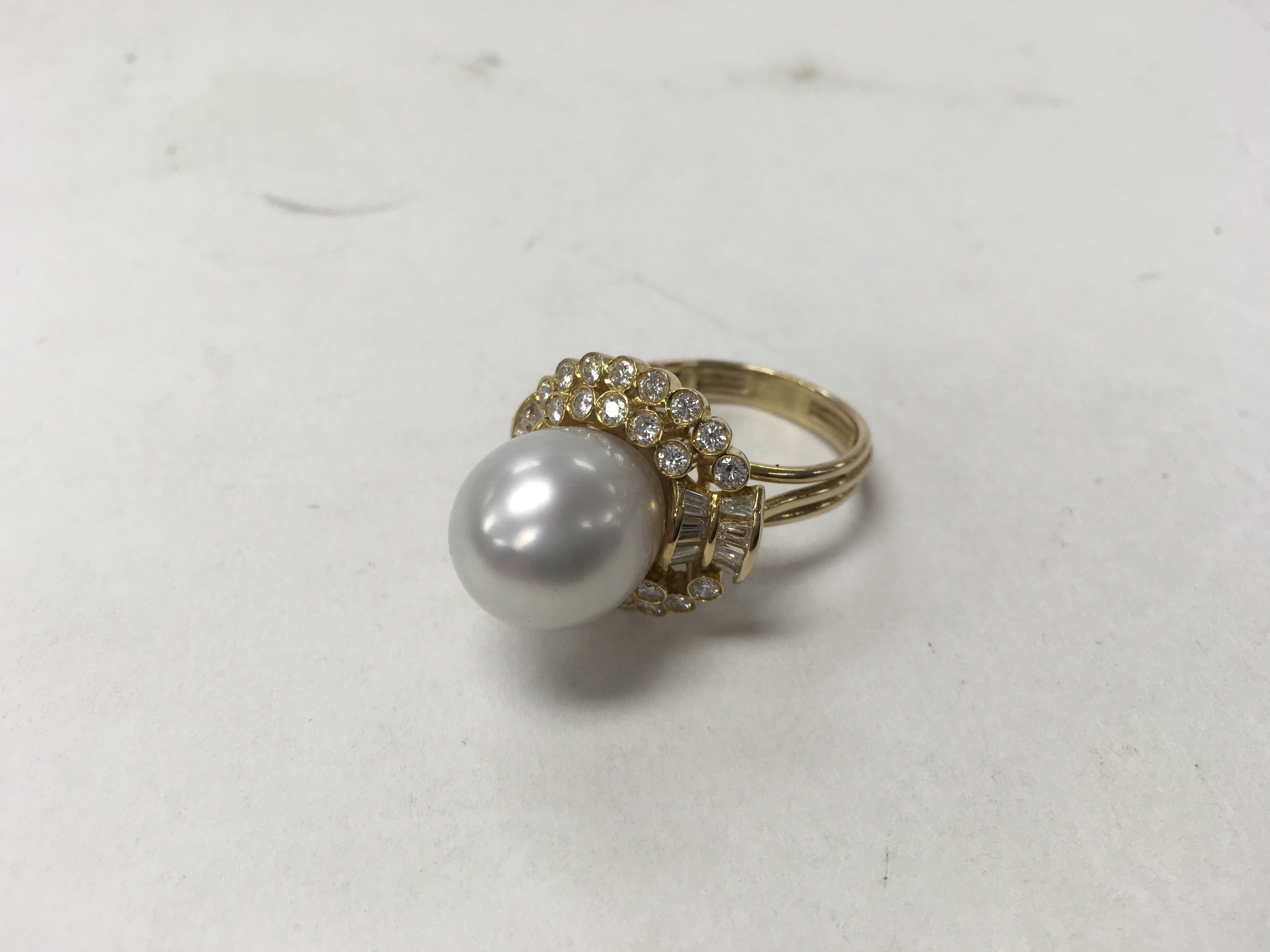 A 14ct gold pearl and diamond ring. Weight approx