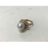 A 14ct gold pearl and diamond ring. Weight approx