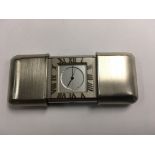 A brushed steel Tiffany & Co.genuine travel clock square dial with Roman numerals