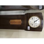 A Mahogany grandmother clock of Art Deco design with a silvered dial.