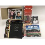 A blue box containing mainly Manchester United memorabilia and other football related ephemera.