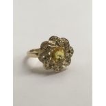 A yellow sapphire and diamond ring 9 ct size 0