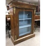 A Victorian walnut pair cabinet the single door en