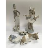 A collection of Lladro figures comprising a boy and a girl dancing, a girl with geese, calf and