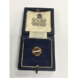 A 9ct gold Esso long service badge in a fitted case and set with a small diamond.