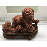 A Chinese goldstone crystal, guardian lion on wood
