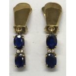 A pair of 9k gold and sapphire clip drop earrings.