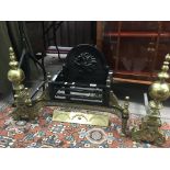 A Victorian style cast iron and brass fire grate with cast dragon motif with heavy brass side