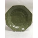 A Chinese octaganol shaped dish with relief floral