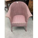 A pink Loyd Loom tub chair