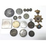 A collection of silver medals and coins.