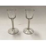 A Pair of 18th Century wine or cordial glasses with slightly moulded bucket bowls on opaque air