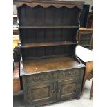 An oak dresser the raised back with open shelfs ab