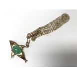 A 9ct gold whale pendant with green coloured stone