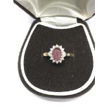 A 9ct gold cluster ring set with red and white sto