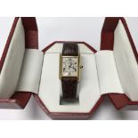 A boxed ladies Cartier watch (not working).