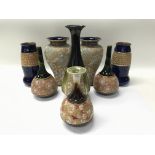 A collection of Royal Doulton vases including Doulton Slater.