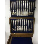 A walnut case containing a set of 12 silver Victor