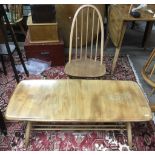 An Ercol light elm coffee table with magazine rack