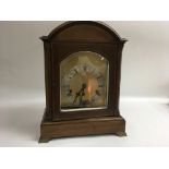 A wooden German made cased mantle clock.