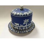 A 19th century Wedgwood type jasper ware cheese dish decorated with cattle and grapevine.