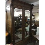 A French armoire, the twin doors with mirrored ins